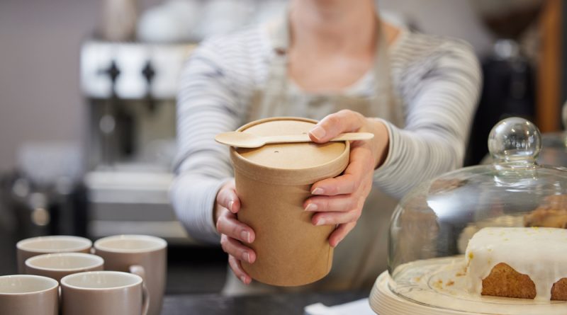Lady serving food in sustainable food packaging